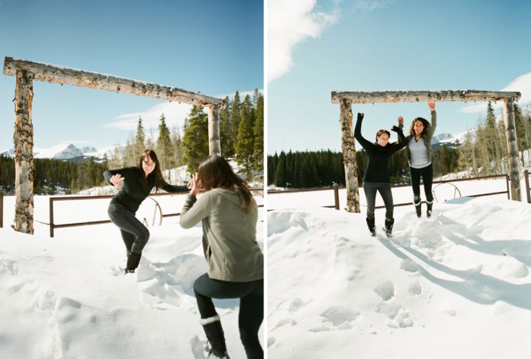 Bride and brides maid jumping off a snow bank 